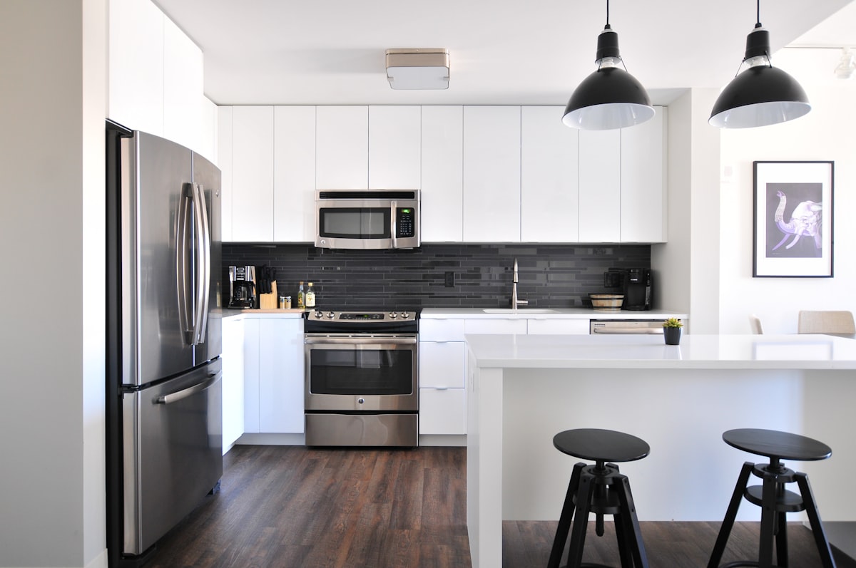 Modern stainless steel three-door refrigerator in a Collier County kitchen